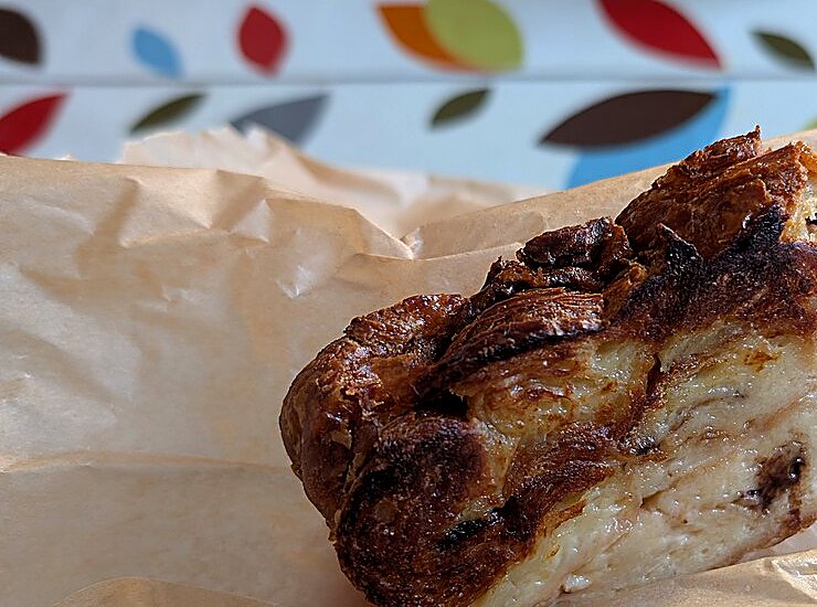 A caramelised slice of croissant bread and butter pudding with silky custard layers