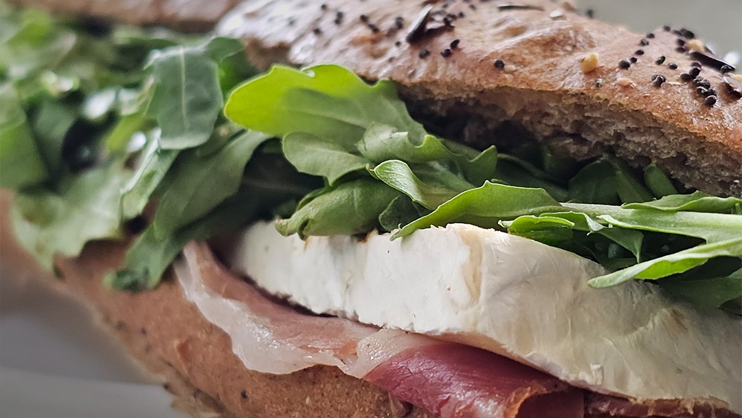 A brie, prosciutto and arugula sandwich on seeded bread baked that morning at La Sucriere, Sint Maarten