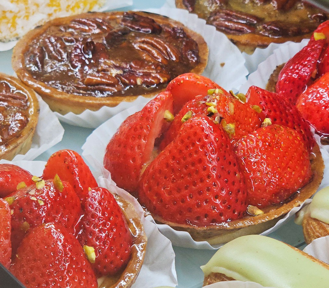 Pecan tarts, strawberry tartlets and pistachio eclairs on the counter at La Sucriere Philipsburg