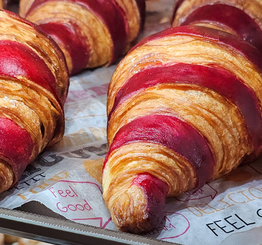 A freshly baked croissant on the counter at La Sucrière