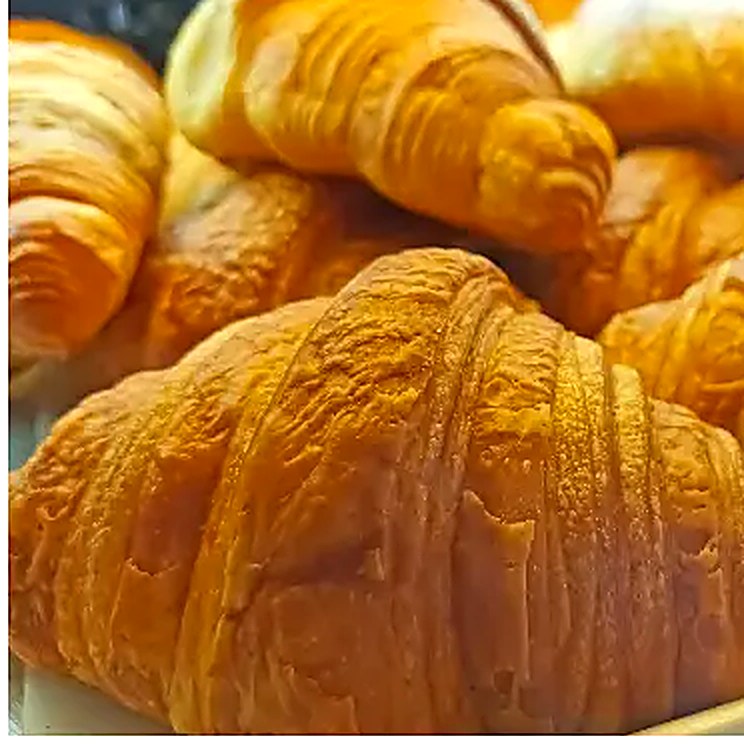Golden butter croissants at La Sucrière — classic, chocolate, almond and love croissants